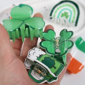 Handheld St. Patrick's Day hair claws featuring clover, rainbow and flag designs