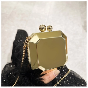 Detailed macro view of the gold octagonal acrylic clutch with a ball clasp and chain