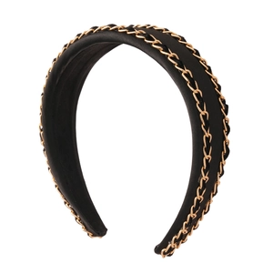 Elegant black fabric headband with gold woven chain detailing for a stylish look