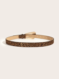 Macro shot of leopard print leather belt with gold metal buckle and multiple adjustment holes
