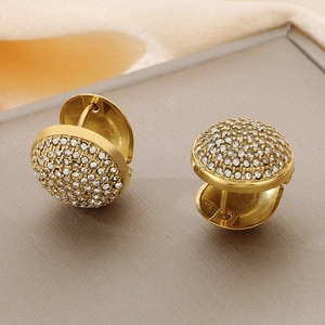 Detail of gold-plated hoop earrings with micro-pave white zircons on a display stand