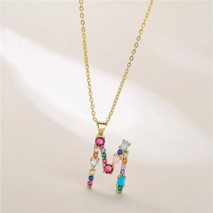 Golden letter M necklace featuring multi-colored gemstones on a delicate cable chain