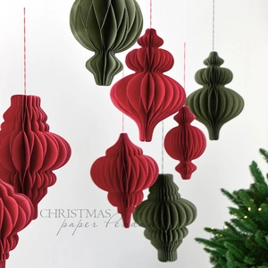 Christmas paper honeycomb pendant ornaments in red and olive green on white background