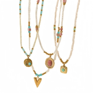 Multilayer beaded necklaces with sunflower turquoise and pink stone pendants on white background