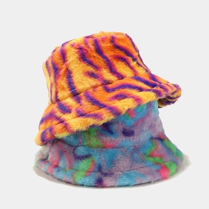 Detail view of colorful tie-dye and orange tiger stripe plush faux fur bucket hats