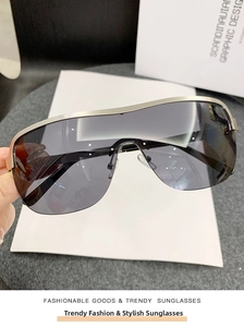 Detail view of champagne gold frame and deep gray one-piece lens cycling sunglasses