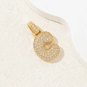 Detailed close-up of gold-plated letter C pendant with shimmering zircon pavé inlay