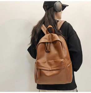 Brown vintage faux leather backpack on model showing size ratio and textured finish