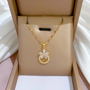 Detail of flower pendant necklace in gold with sparkling micro-pave zirconia crystals