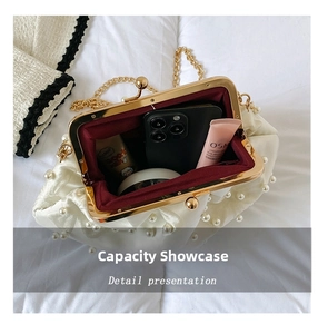 Interior view of pearl cloud evening bag showing large storage capacity for essentials