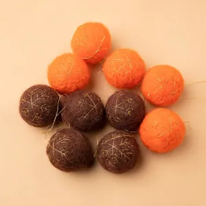 Plush wool felt Christmas balls in orange and brown with golden snowflake embroidery