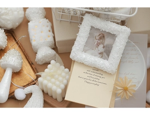 Detail of white beaded photo frame with pearl texture and festive greeting card