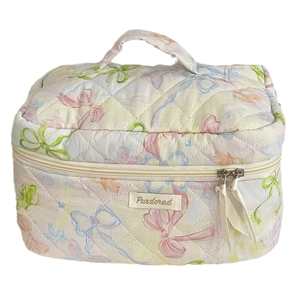 Quilted cotton makeup bag with colorful ribbon patterns and top handle in beige