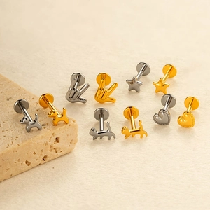Collection of titanium heart and star flat back ear and labret piercing studs in gold and silver