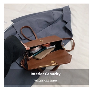 Detail shot of the brown leather crossbody bag showing its spacious inner compartment