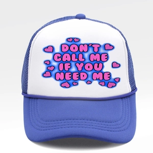 Detail of blue and white trucker hat with pink Don't Call Me text and mesh texture