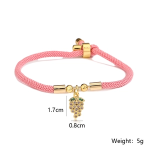 Detail showing 1.7cm grape pendant with purple zircons on a pink woven cord bracelet