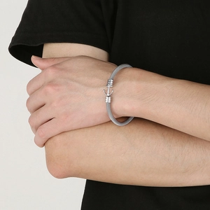 Detail view of woven stainless steel mesh bracelet with anchor clasp on model's wrist
