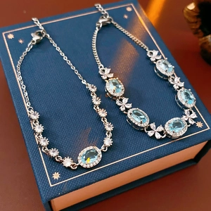 Close-up of floral bracelets with oval blue stones and silver plating on jewelry box