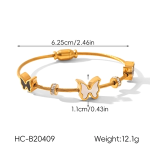 Detail of 18k gold butterfly twisted wire bracelet with inlaid stones and size dimensions