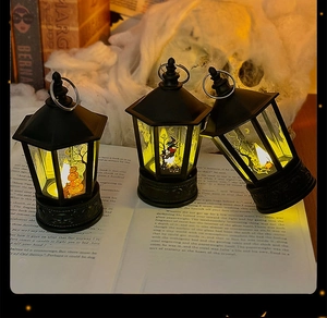 Retro Halloween LED lanterns with pumpkin and skull patterns on vintage book decor