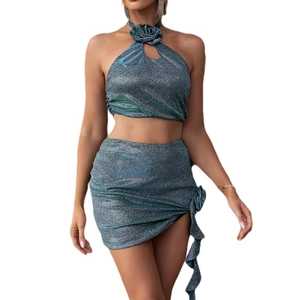Sultry two-piece set featuring 3D flower halter top and metallic mini skirt in blue-green