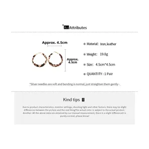 Detail of leopard print leather hoop earrings with silver pins and 4.5cm diameter