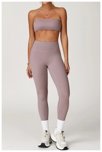 Detailed view of high-waist mauve yoga leggings and matching bandeau sports bra set