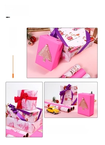 Pink Christmas wrapping paper with snowmen and tree patterns shown on gift boxes