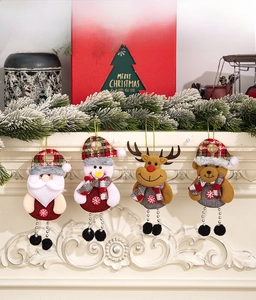 Detail von Weihnachtsmann, Schneemann und Rentier Anhängern auf dem Kaminsims