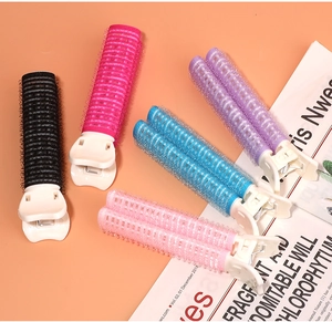 Detail of five colorful hair root clips on a magazine to show textures and vibrant colors