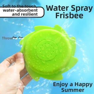 Macro detail of a green water sprinkler disc toy spraying water during outdoor pool play