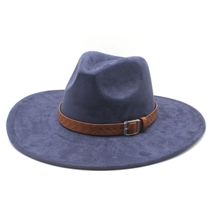 Close-up of a dark navy faux suede wide-brim fedora hat with a woven brown leather band