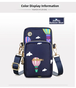 Detail of blue nylon crossbody bag featuring colorful hot air balloon patterns and headphone jack