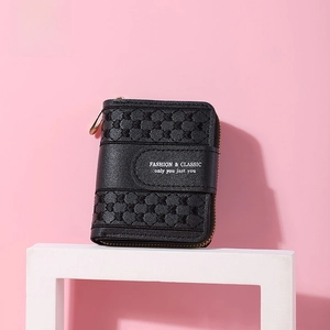 Close-up of black short wallet featuring a luxury woven texture and gold zipper detail