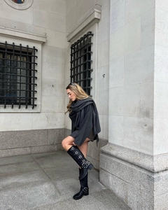 Detail of black knee-high boots with multiple metal buckles and fashion scarf style