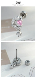 Detail of silver heart ear piercing with pink zirconia and threaded flat back design