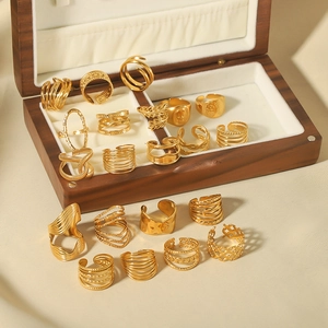Set of minimalist gold-plated stainless steel geometric open rings in wooden jewelry box