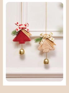 Detail of red and beige felt Christmas tree ornaments with ribbons and golden bells