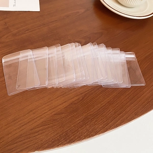 Close-up of clear PE plastic jewelry ziplock bags organized on a wooden surface