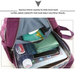 Detailed internal view of purple nylon backpack showing ultra large storage capacity