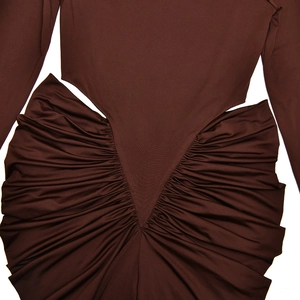 Detailed close-up of brown V-shaped ruched fabric and textured pleated dress stitching