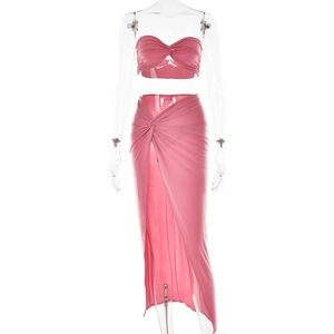 Detail view of pink two-piece set featuring a twisted bandeau top and side slit maxi skirt