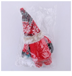 Detail of Christmas plush gnome in red outfit and striped pointed hat in clear packaging