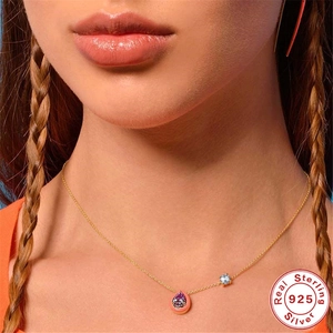Sterling silver 925 gold necklace with pink teardrop pendant and purple crystal on model