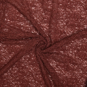 Detailed view of dark red lace fabric with intricate floral patterns and soft drape texture