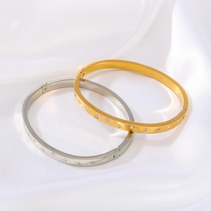 Star-patterned stainless steel bangles set with sparkling zircon stones on white silk
