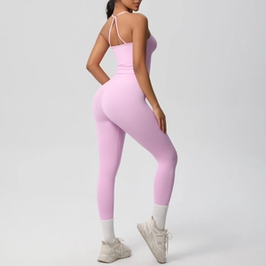 Detailed back view of pink yoga set featuring criss-cross straps and lifting leggings