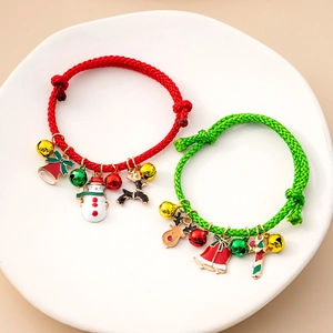 Christmas theme woven bracelets with red and green cords featuring reindeer and bell charms