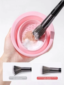 Close-up of pink silicone cleaning bowl showing textured surface and folding design